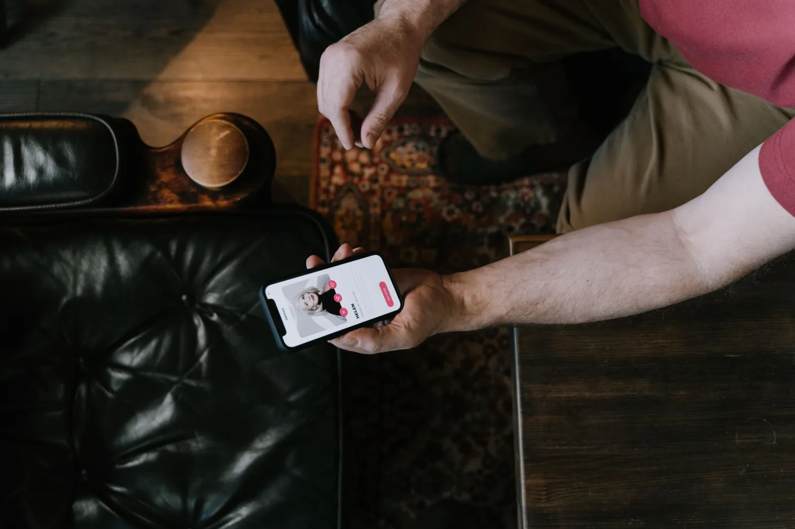 Person holding a smartphone with dating matching app on screen